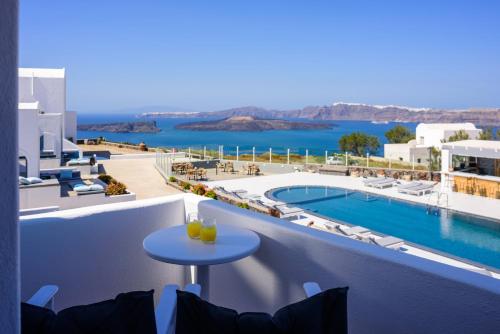a view from the balcony of a hotel with a pool at Kalestesia Suites in Akrotiri