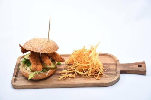 a sandwich and french fries on a cutting board at HB Torrevieja in Torrevieja