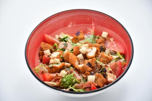 a red bowl filled with food on a white surface at HB Torrevieja in Torrevieja