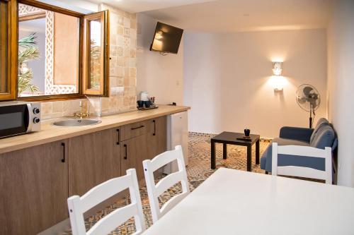 a kitchen with a sink and a table with a microwave at LA CASA MORISCA in Alicante