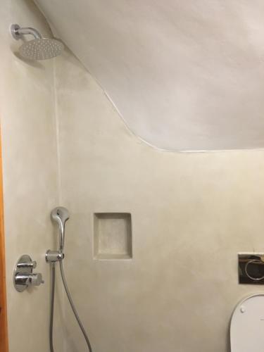 a shower in a bathroom with a shower head at Διαμέρισμα 4 ατόμων-Cozy Family apartment close to the most beautiful beaches in Athanion