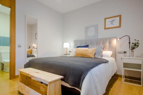 een slaapkamer met een groot bed en een tafel bij La Casa del Mar in Chiclana de la Frontera