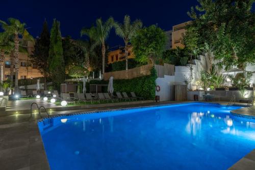 a swimming pool in a hotel at night at Hotel Costa Málaga - Adults Recommended - by Pierre & Vacances in Torremolinos