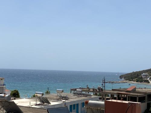 a view of a beach with the ocean in the background at Georgina in Agia Marina Aegina