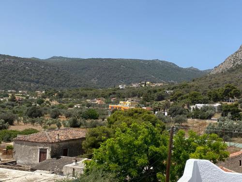 a view of a village with mountains in the background at Georgina in Agia Marina Aegina