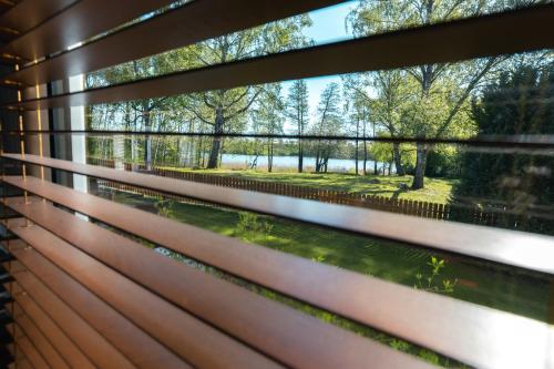a window view of a park through a fence at Wila Dom Nad Jeziorem Mazury in Sorkwity