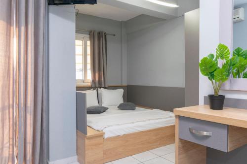 a small bedroom with a bed with a window at Agnandi in Neos Marmaras