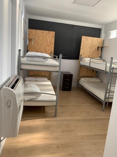 a room with three bunk beds in a room at Bilbao Central Rooms in Bilbao
