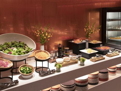 a buffet of food on a counter in a restaurant at Hyatt Place Kyoto in Kyoto