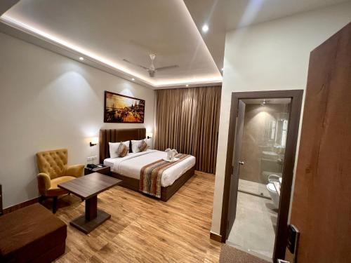 a hotel room with a bed and a bathroom at Sugar Stars Inn in Varanasi