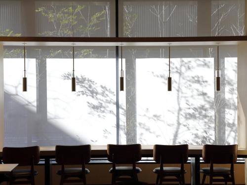 a table with chairs in front of a window at Hyatt Place Kyoto in Kyoto