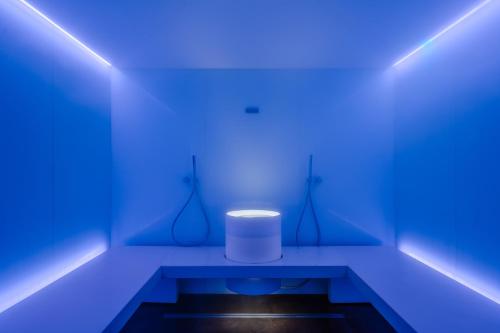 a blue room with a white stool in it at Grand Hotel Bristol Spa Resort, by R Collection Hotels in Rapallo