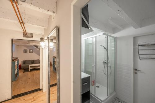 a bathroom with a walk in shower and a glass door at City Center Lofts in Vienna