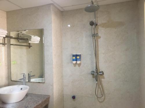 a bathroom with a shower and a sink at Khách sạn NHẬT MINH Cửa Lò in Cửa Lò
