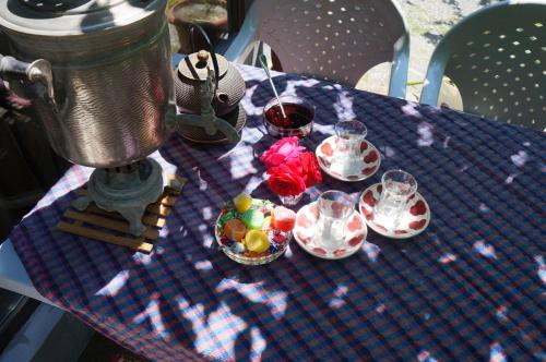 a table with bowls of fruit and glasses on it at Woodland Paradise in Gabala