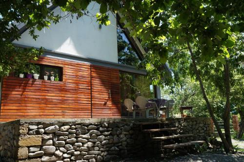 a house built on a stone wall with a stone fence at Forest house in Gabala
