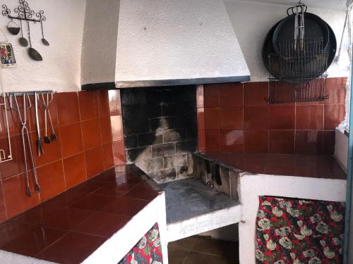 a kitchen with a counter with a fireplace at Chalet con piscina privada en Vinaròs in Vinarós