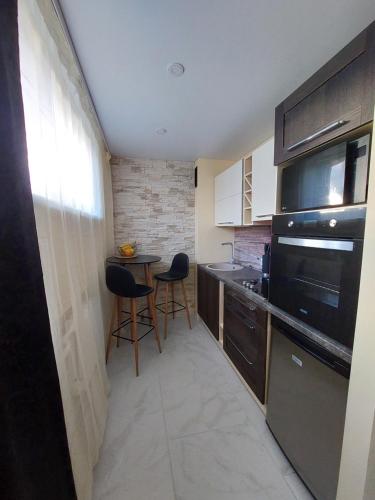 a small kitchen with a table and two chairs at Narva mnt 23``` in Jõhvi