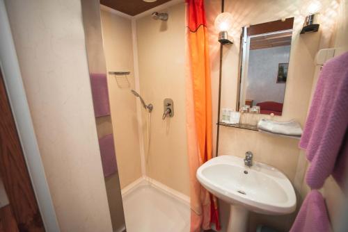 a small bathroom with a sink and a shower at Duna-Party Pansion in Budapest