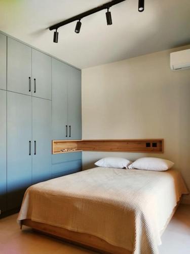 a bedroom with a large bed with two pillows at Lydia's Rainbow in Preveza