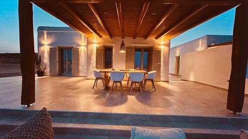 a patio with a table and chairs on it at Aeris suites Pori in Koufonisia