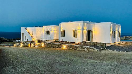 a row of white buildings with lights on them at Aeris suites Pori in Koufonisia
