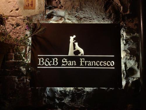 a sign on a wall that reads bbb san francisco at Domus San Francesco in Assisi