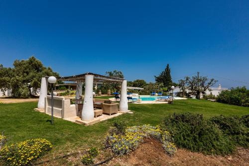 a garden with a gazebo and a pool at Masseria La Cazzigna by Perle di Puglia in Pezze di Greco