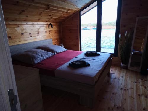 a bedroom with a bed with two shoes on it at House ThoNi in Gornji Štoj