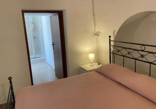 A bed or beds in a room at Trulli Ulivi