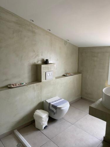 a bathroom with a toilet and a sink at Perland Vacation in Sidari