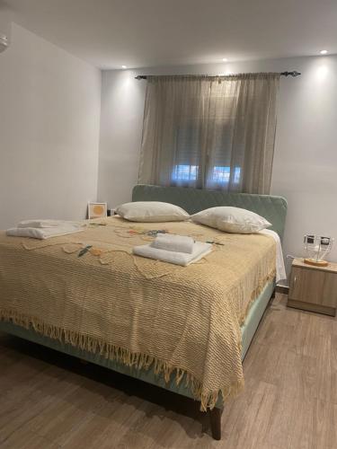 a bedroom with a large bed with a window at Perland Vacation in Sidari