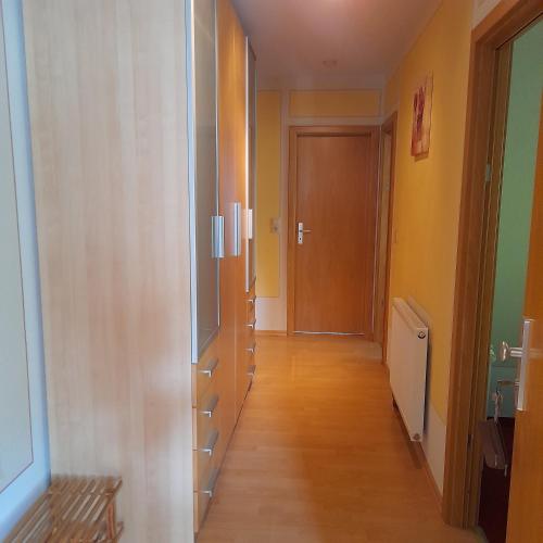 a hallway with wooden floors and a door to a room at Ferienwohnungen Herrmann in Bad Schandau