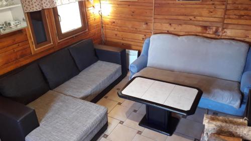 an overhead view of a living room with a couch and a table at CHATA STRÁŽ in Stráž nad Nežárkou