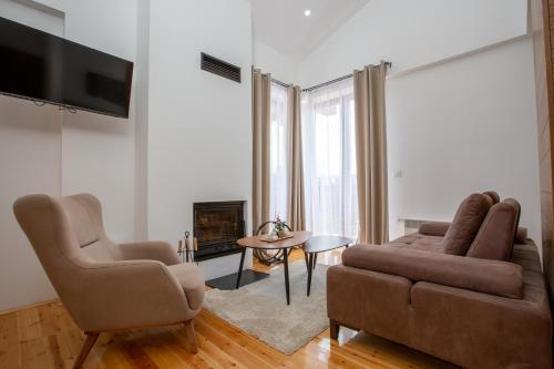 a living room with a couch and two chairs at NORTH STORY - Luxury Chalet - Apartments & rooms in Žabljak