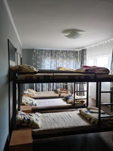 a group of five bunk beds in a room at Smilgas in Riga