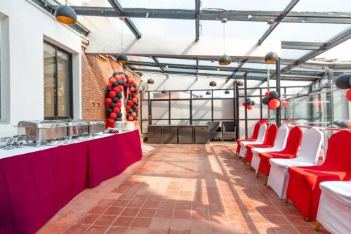 a room with red and white chairs and a bar at Mahabir Palace in Kathmandu