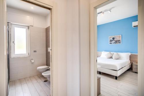 a bathroom with a toilet and a bed in a room at Apartment Baccus in Sorrento