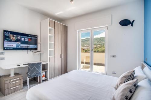 a bedroom with a bed and a desk and a television at Apartment Baccus in Sorrento
