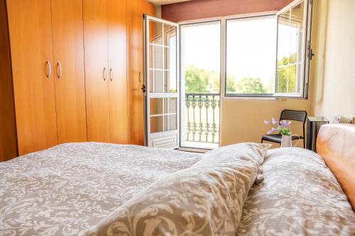 a bedroom with a bed and a large window at Apartamento Ultreia in Palas de Rei