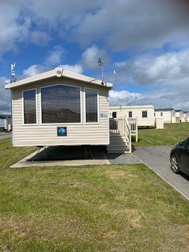 a mobile home is parked in a parking lot at Cosy caravan in Hull