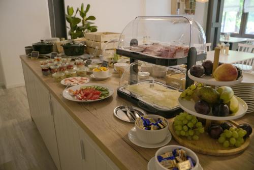 a buffet with many plates of food on a counter at Ley Hotel in Klotten