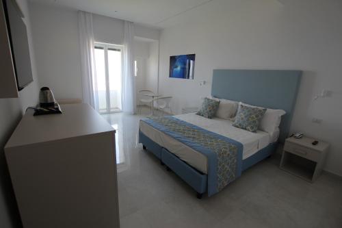 a small bedroom with a bed and a window at Hotel Lucia in Castellammare di Stabia