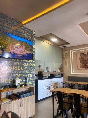 a dining room with a table and a large screen at Hotel Dakhla Ville in Dakhla