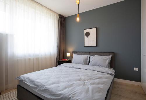 Katil atau katil-katil dalam bilik di Olimpia Residence District Satu Mare