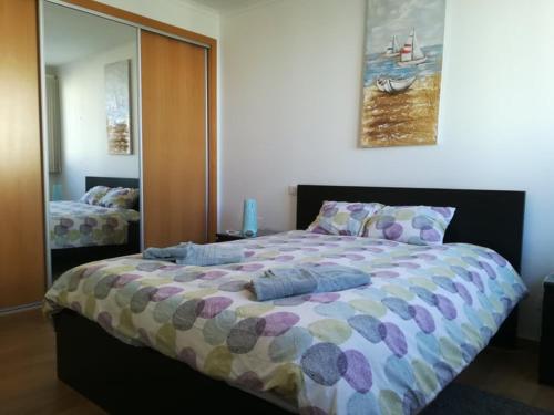 a bedroom with a large bed with pillows on it at B&B O Pescador in Nazaré