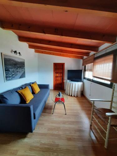 a living room with a blue couch and a table at FINCA VALENZUELA in Mijas