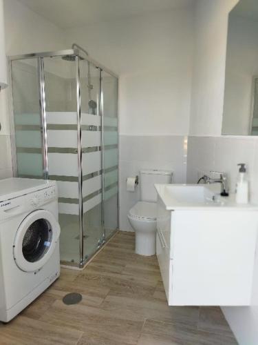 a bathroom with a washing machine and a sink at FINCA VALENZUELA in Mijas