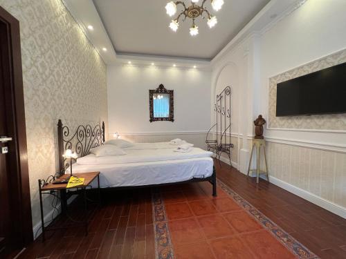 a bedroom with a bed and a television on the wall at Hotel Boutique Cathedral Plaza Residences room for rent downtown in Bucharest