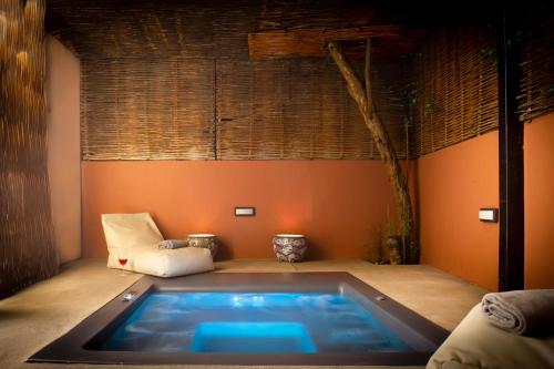 a hot tub in a room with a chair at SV Acropolis Residence in Athens